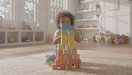 Child playing with colorful blocks, created with VideoGen