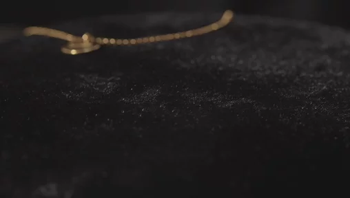 Close-up of a gold name necklace, created with VideoGen