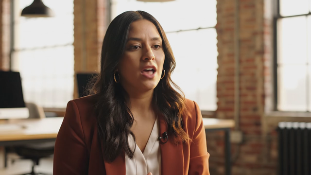 Documentary-style interview: a founder in a bright loft office says 'We didn't set out to build a company, we set out to fix a problem', natural window light, shallow depth of field